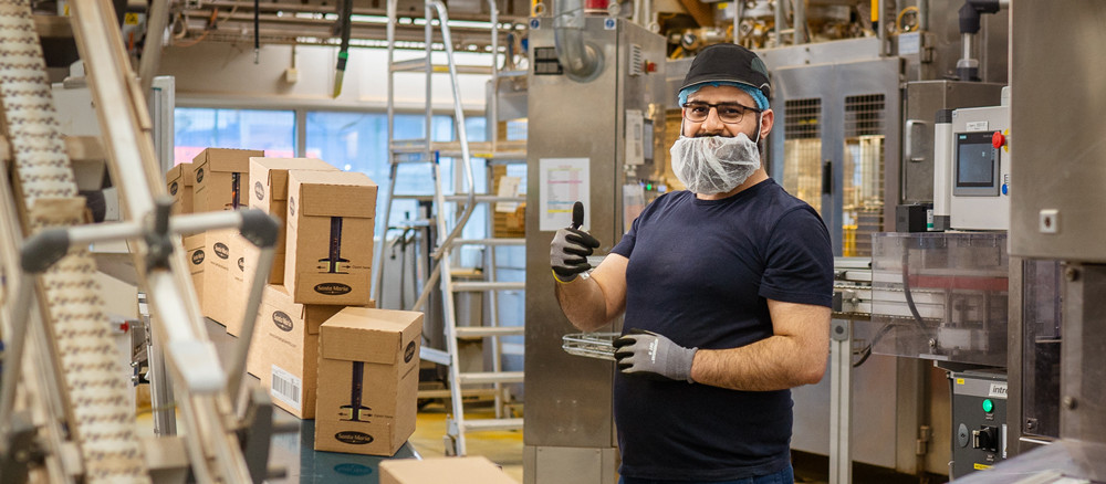 Mölndal factory employee standing by production line