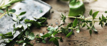 Oregano and a knife on a cutting board